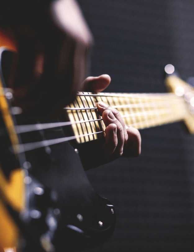 Someone playing a guitar close up.