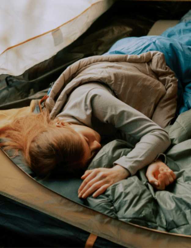 Woman sleeping in a tent.