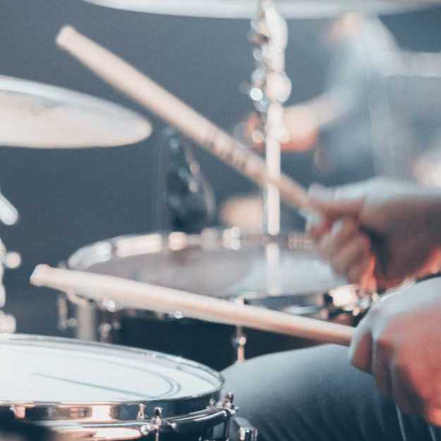 Close up of someone playing the drums.