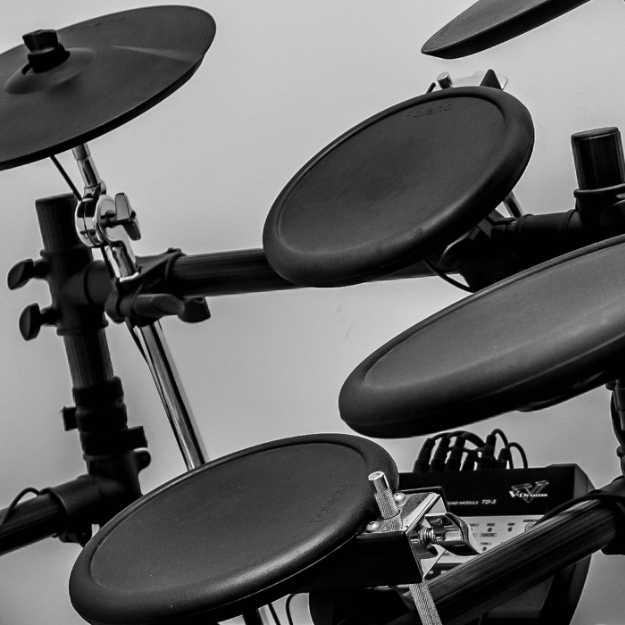 Black and white photo of a electric drum set.