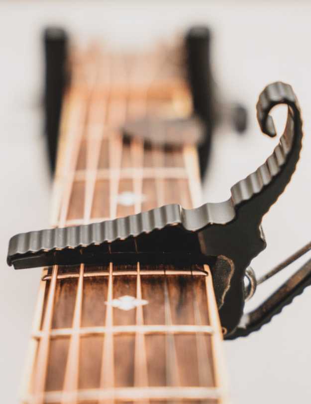 Close up of a capo on a guitar.