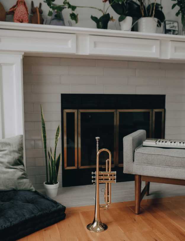A trumpet standing still in a livingroom