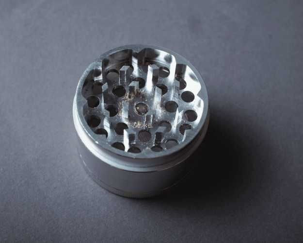 A silver grinder with the top off
