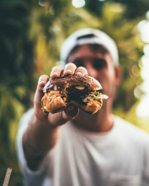 Man holding a cheese burger