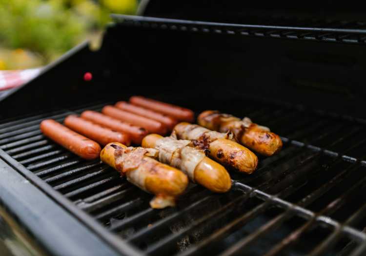 Bacon wrapped hot dogs being grilled!