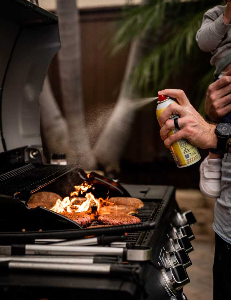 Oiling the grill with spray butter!