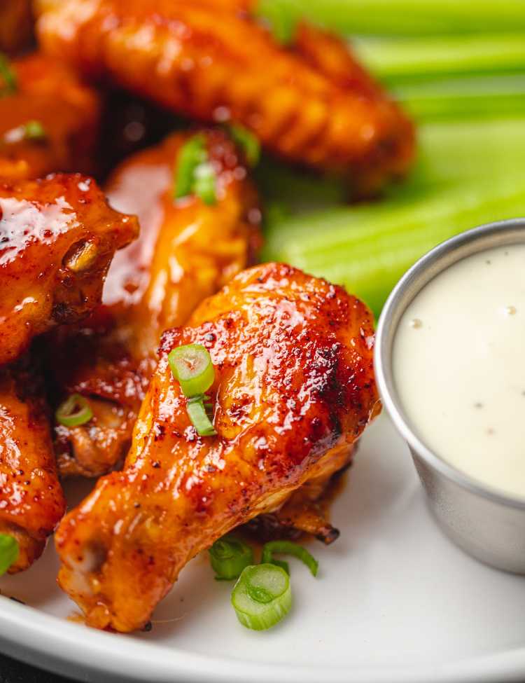 Saucy chicken drumsticks paired with green onion, celery, and ranch!