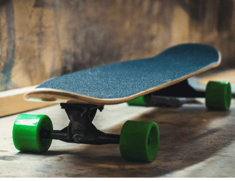 Front view of a skateboard with green wheels