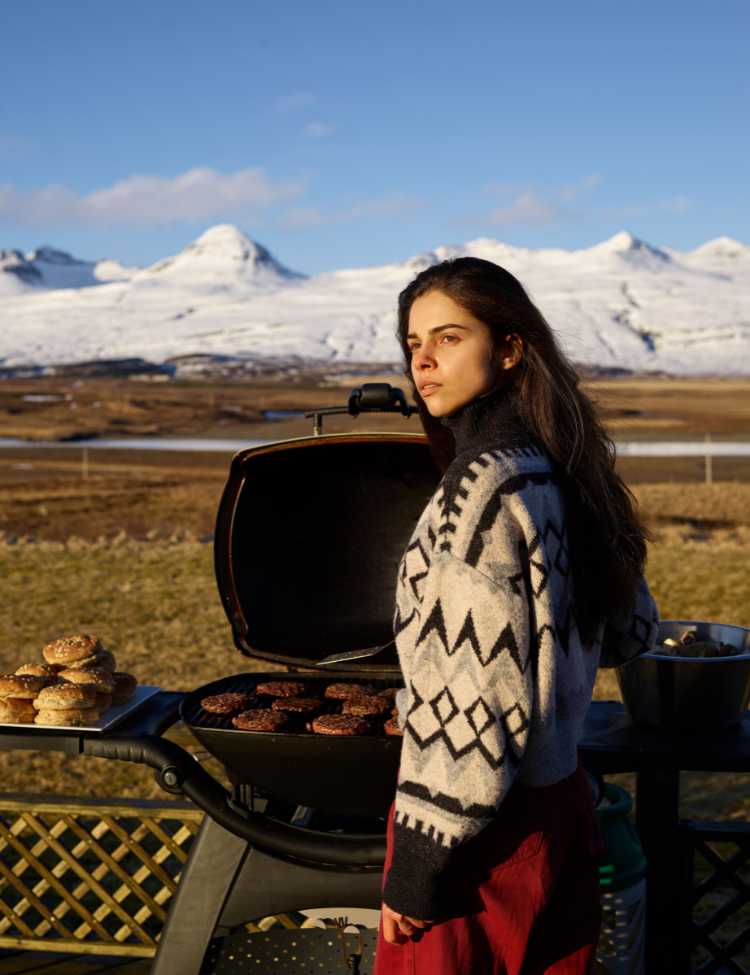 Woman cooking burgers in mountainous terrain! 