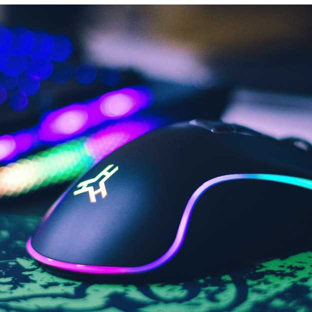 A glowing mouse on a mouse pad with a glowing keyboard in the background.
