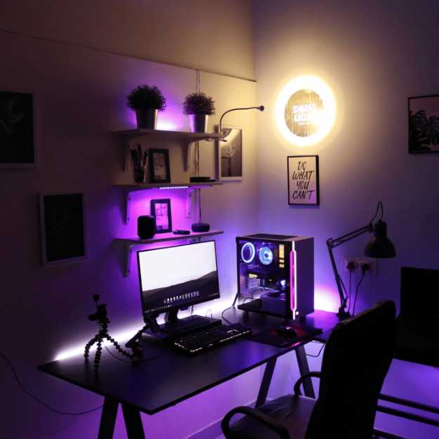 A Dark lit room of a gaming setup.