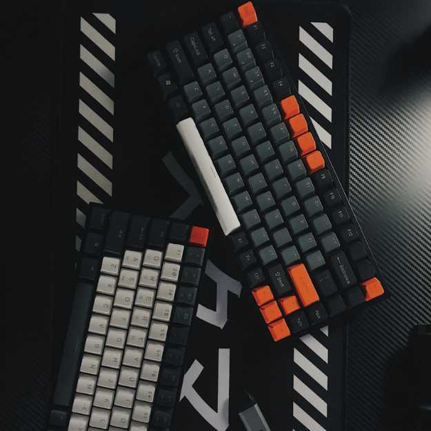 Multiple gaming keyboards on a gaming desk.