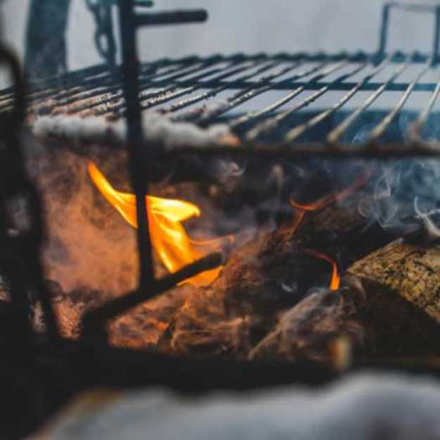 Close up of a fire under a wire grill.