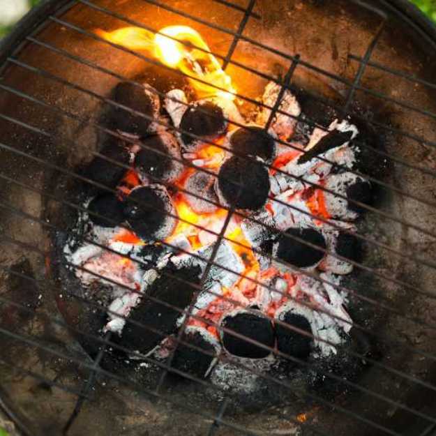 A Grill filled with charcoal.