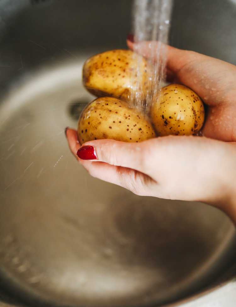 Washing the potatoes before boiling them!