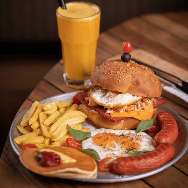 A Breakfast burger with various breakfast foods.
