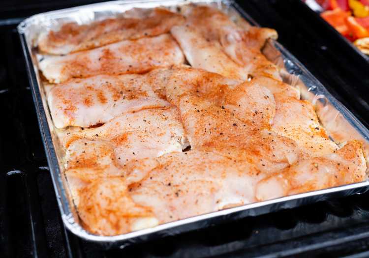 Chicken breast batch, all seasoned up in a pan, ready to be grilled!