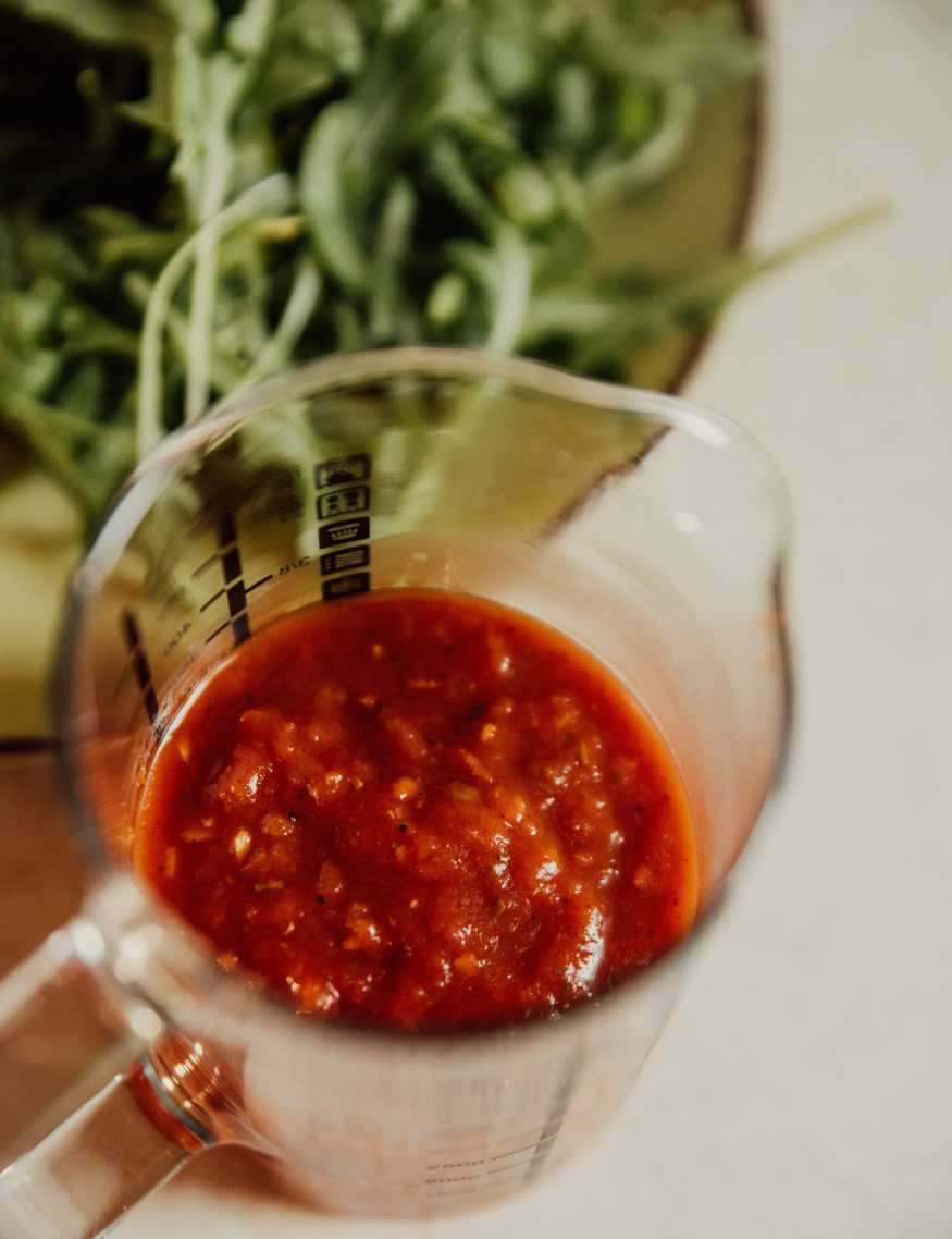 Pizza sauce in a measuring glass