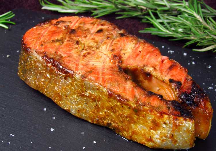 Salmon on a gray dinner table with seasonings