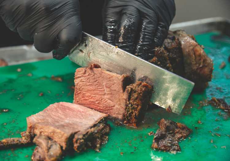 Chef slicing a thick chunk of prime rib!