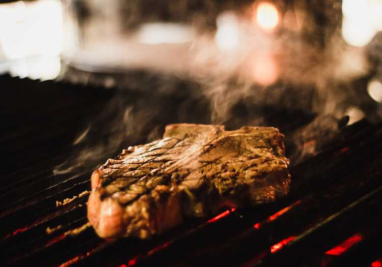 T bone steak being grilled on a large pellet grill!
