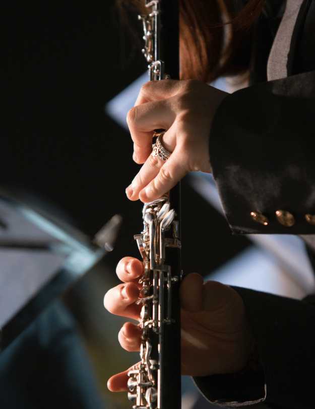 Woman handling a clarinet.