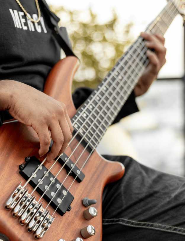 A colored person playing a bass.