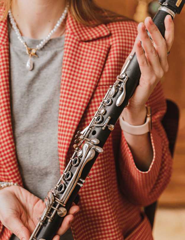 Woman show casing a clarinet.