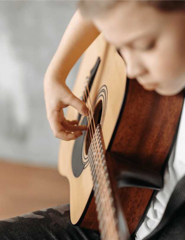 A child playing a guitar.