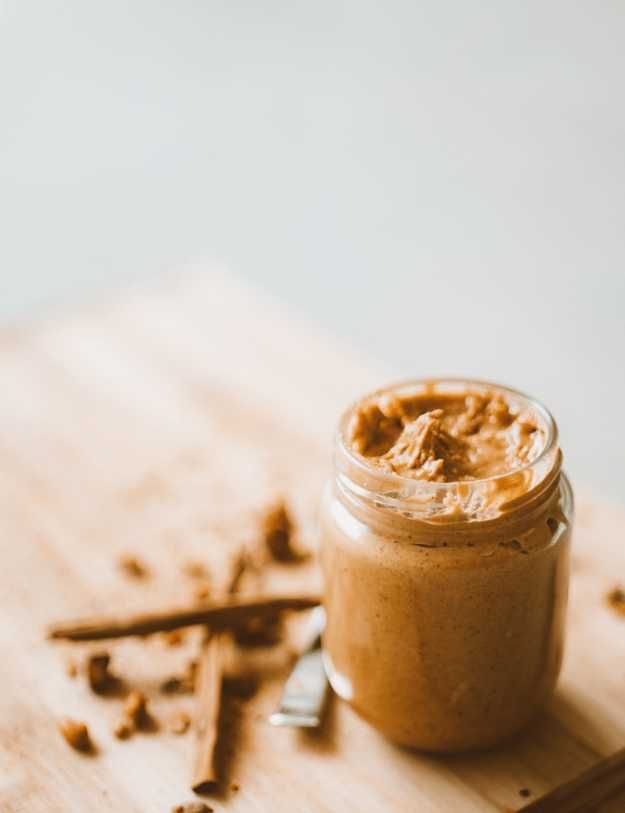 A jar of peanut butter on a table.