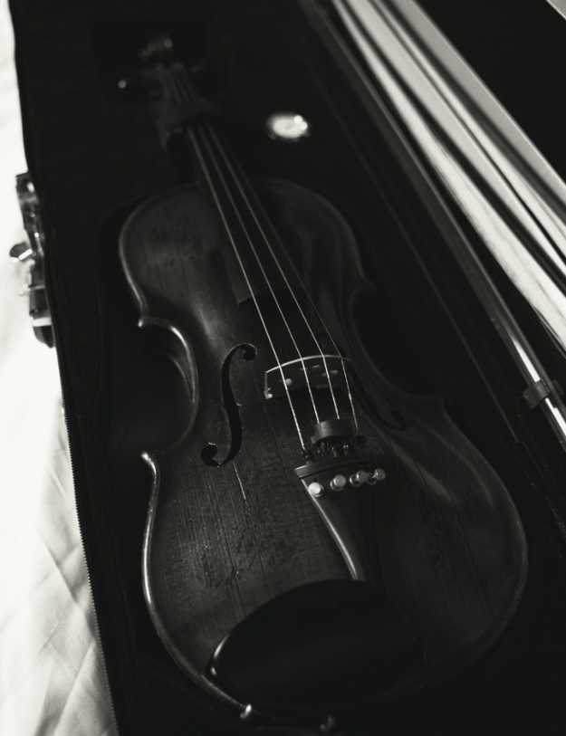 Black and white photo of a violin in its case.