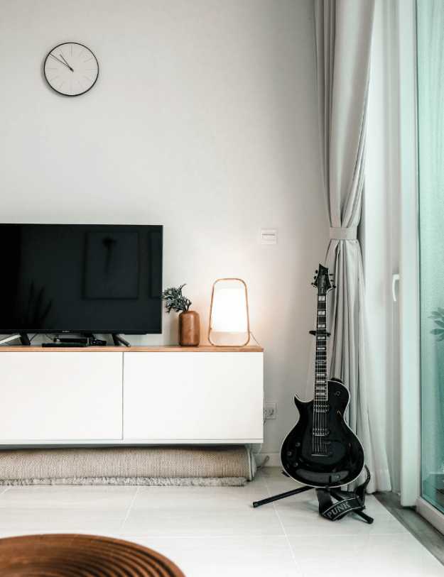 A guitar in a livingroom space.