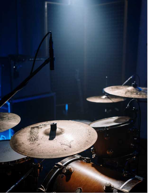 Side view of a drum set on a stage.
