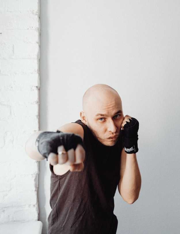 Male boxer posing with hand wraps on