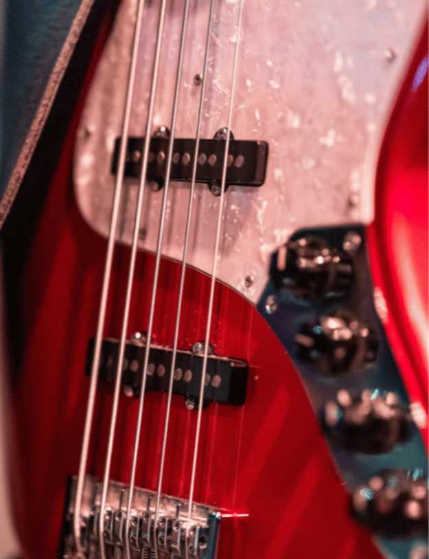 A close up of a red guitar