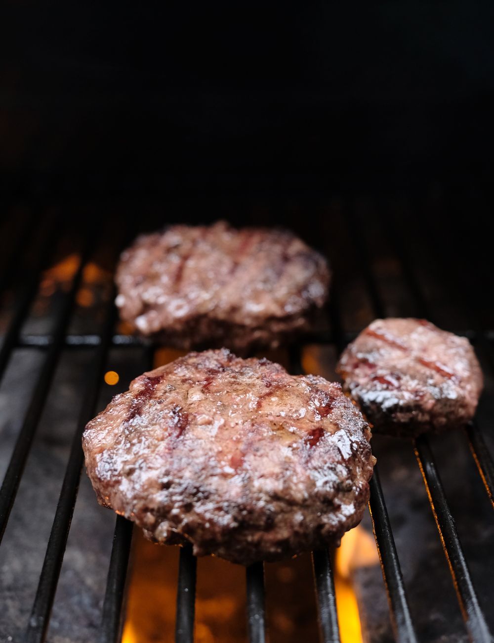 3 Juicy burgers being grilled! Good sear marks.