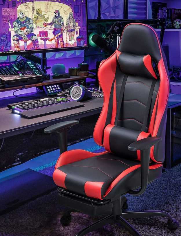 A Gaming Set up with a red and black gaming chair.