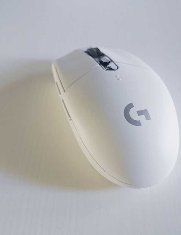A white mouse on a white desk.