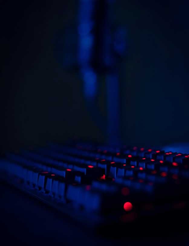 A keyboard in the dark with red RGB.