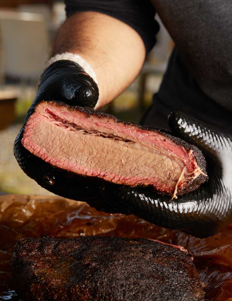 Perfectly cooked brisket being held up to show!